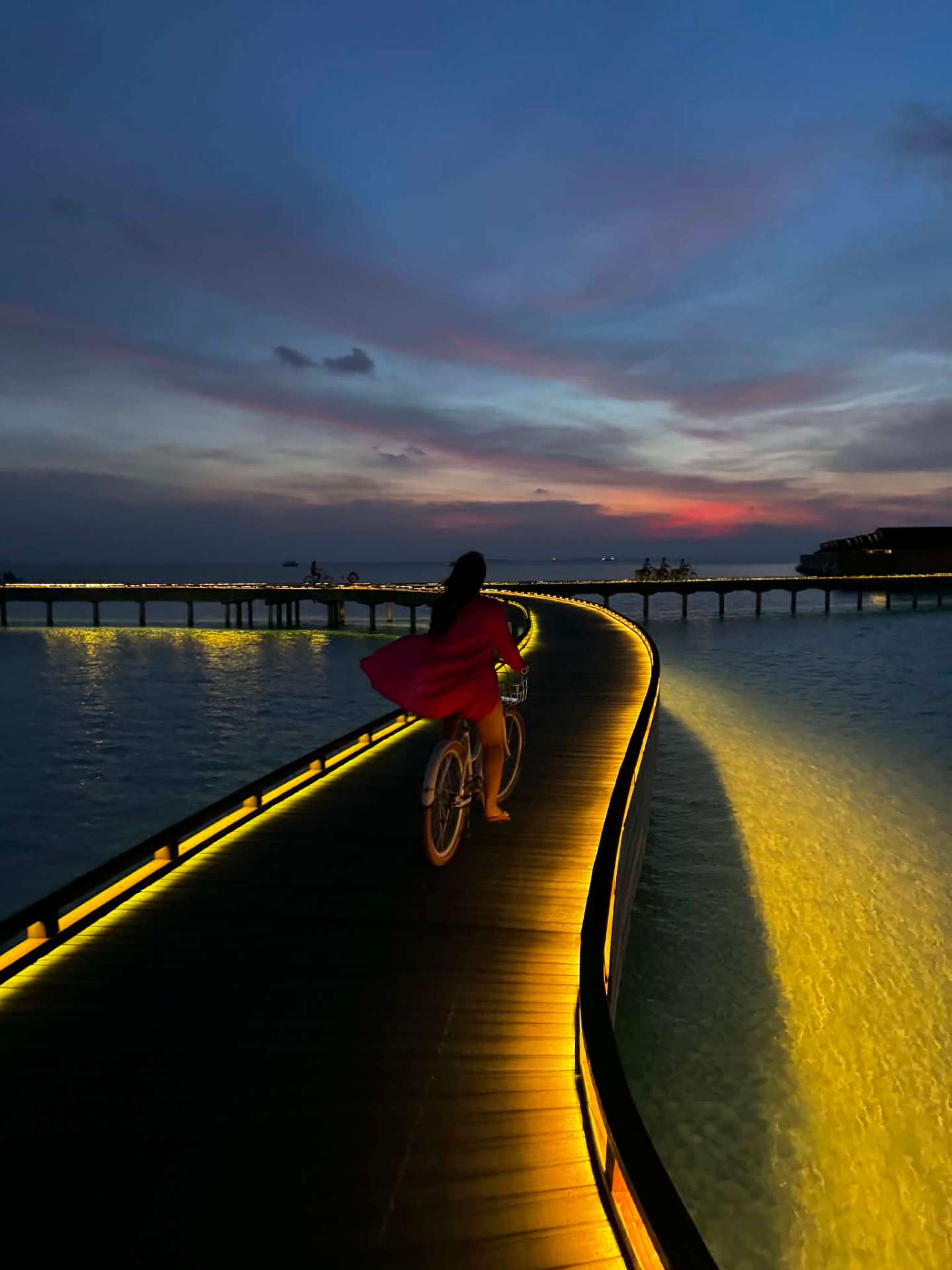 Bike ride along the boardwalk at sunset, Maldives
