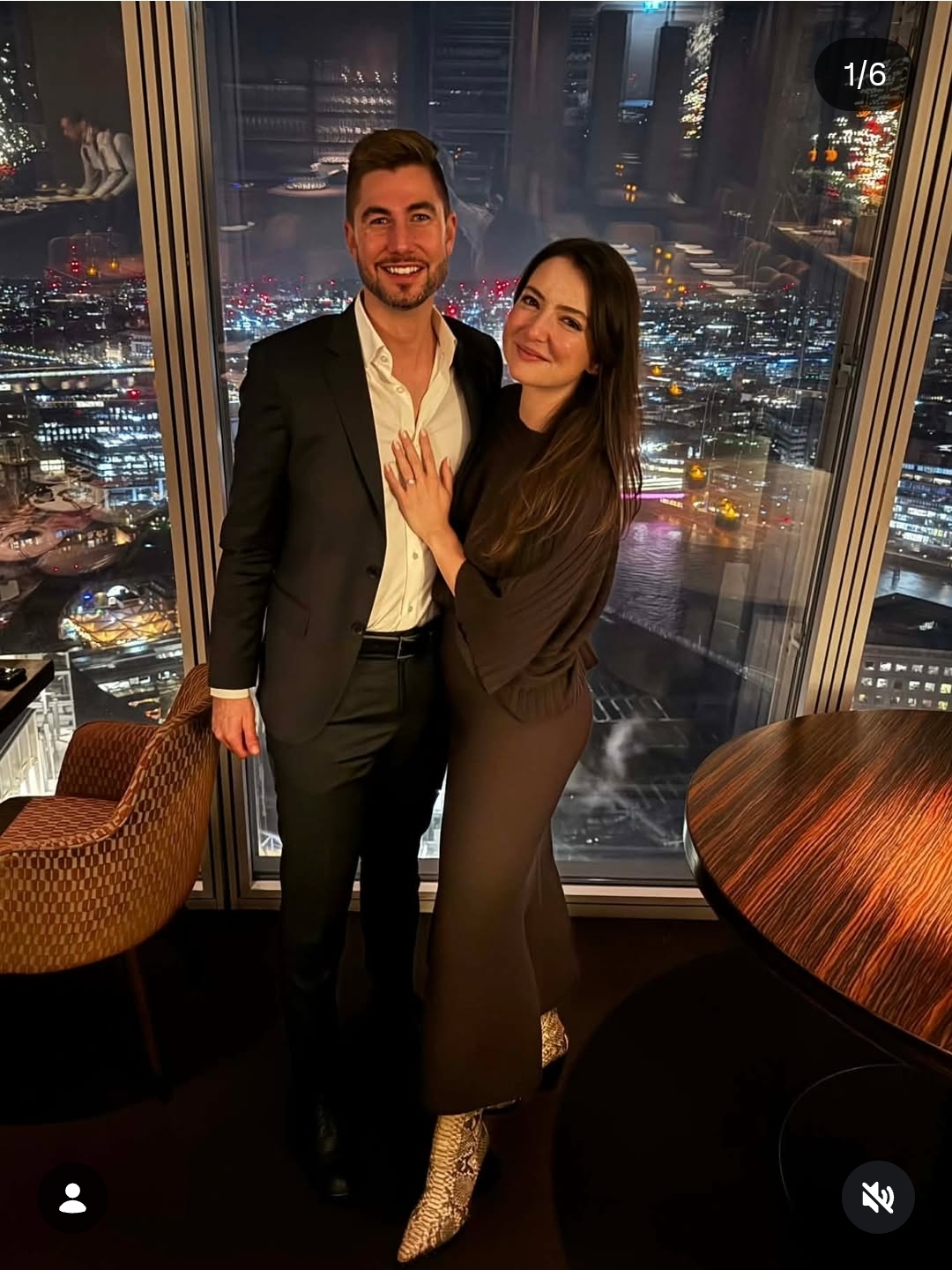Anthony and Raisa dressed up with a city skyline view